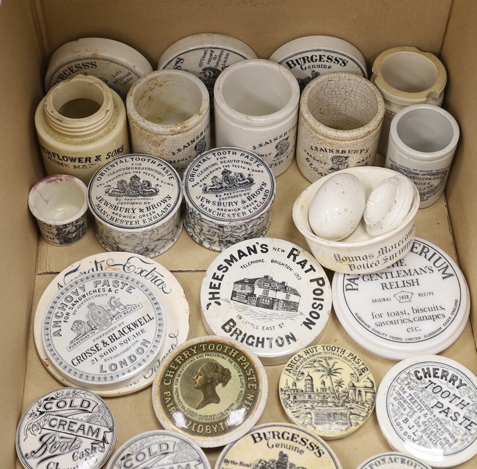 A large collection of anchovy paste toothpaste pot lids and pots together with a Brighton Cheesmans rat poison pot lid